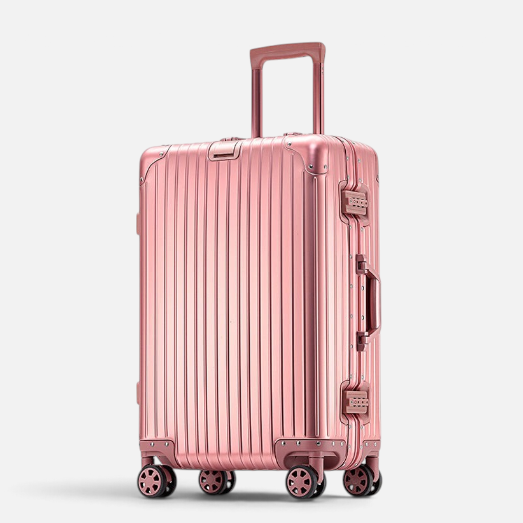 Valise MoovNext AURA en aluminium et magnésium rose métallique avec design rainuré et quatre roues multidirectionnelles