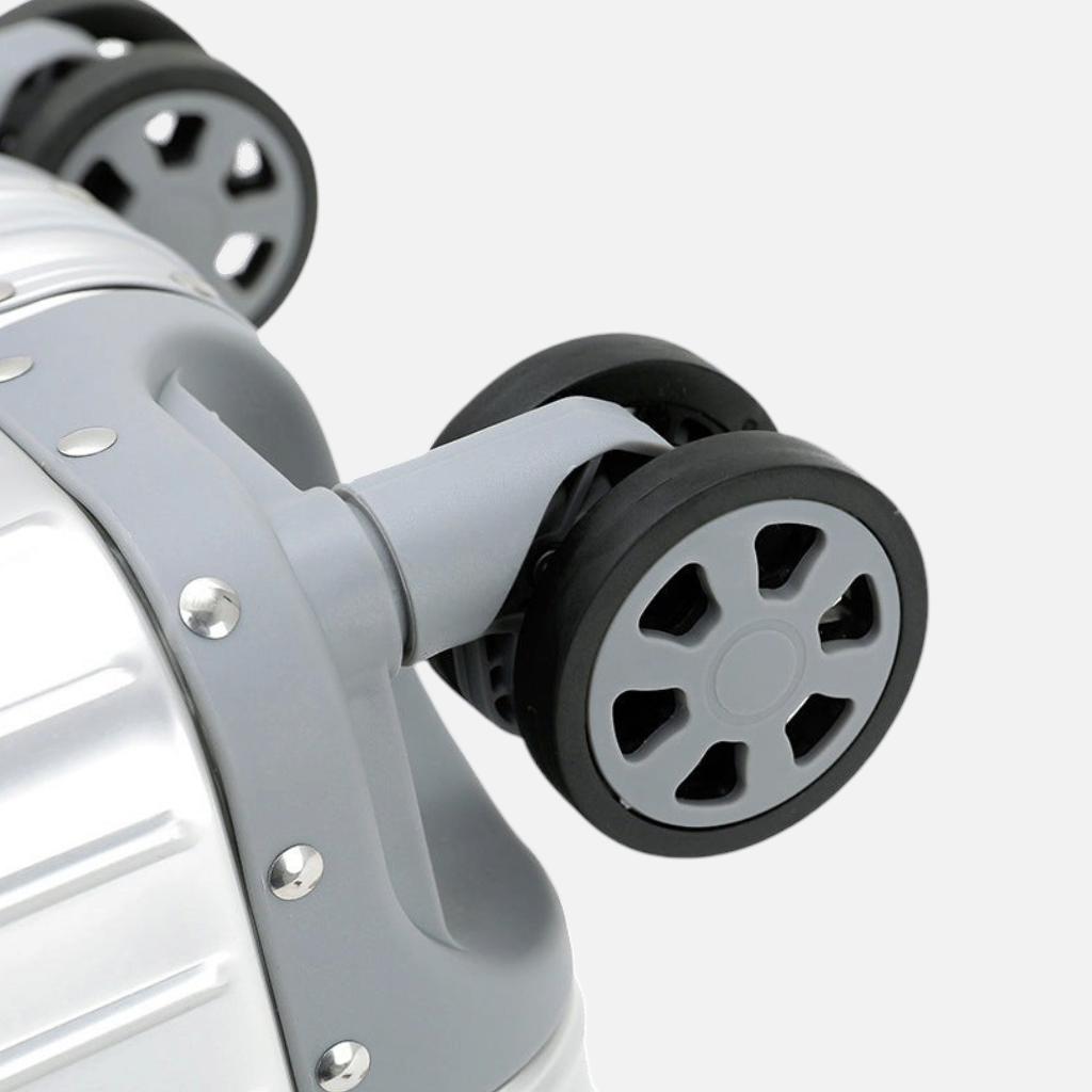 Gros plan sur les roues doubles pivotantes grises de la valise MoovNext AURA en aluminium et magnésium