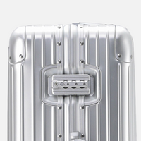 Gros plan sur la serrure TSA d'une valise MoovNext AURA en aluminium et magnésium argenté avec finition rainurée